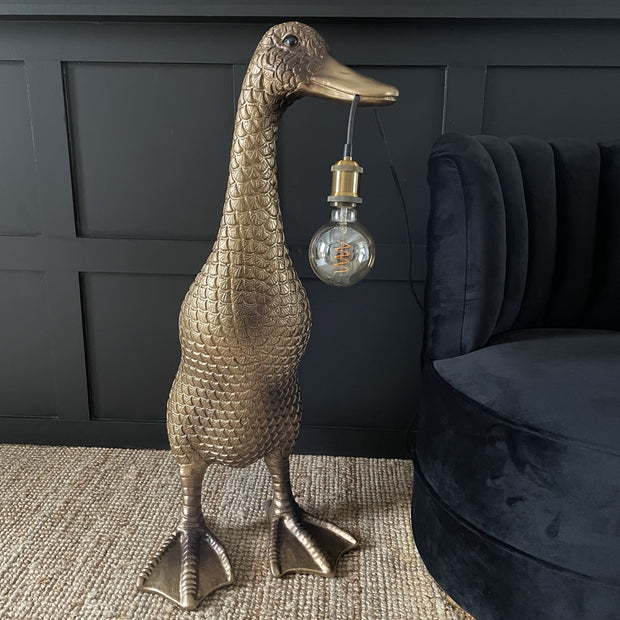 Large gold & brown duck floor lamp with a bulb hanging out it's mouth