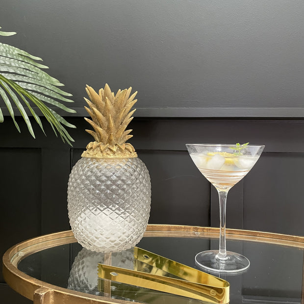 Clear glass pineapple jar with a gold lid