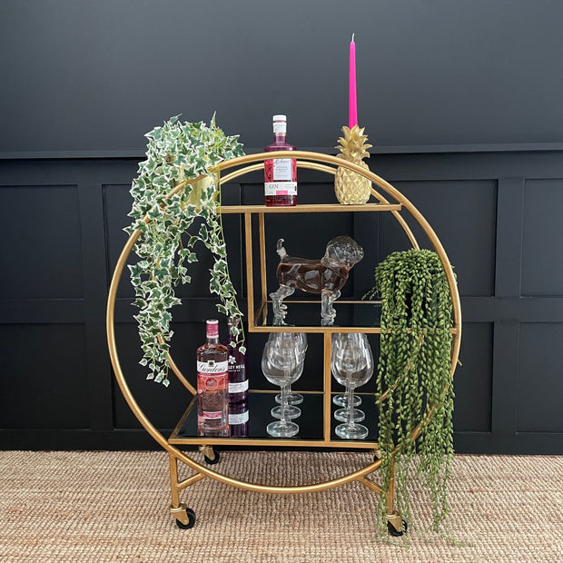 Circular gold drinks trolley with three staggered mirror shelves 