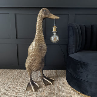 Large gold & brown duck floor lamp with a bulb hanging out it's mouth