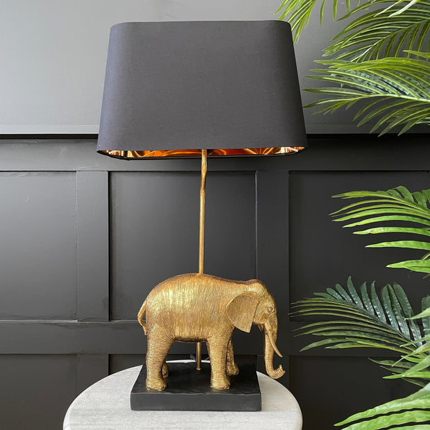 Gold elephant table lamp with a black lampshade