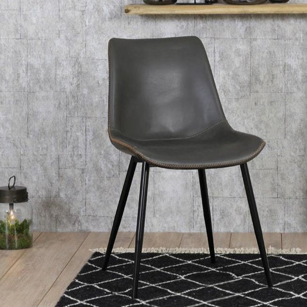 Grey faux leather dining chair with four black legs