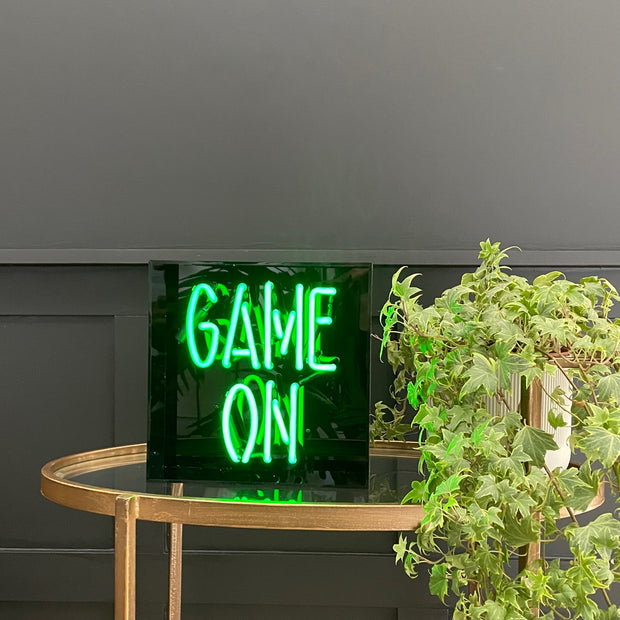 Green neon black sign box with game on