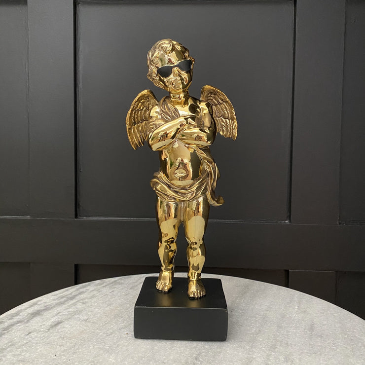 Gold cool cherub statue with arms crossed & black sunglasses