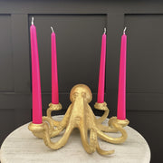 Gold octopus candle stick holder with neon pink candles