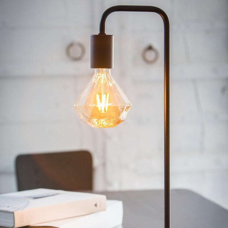 Matte black gooseneck table lamp with a geometric bulb