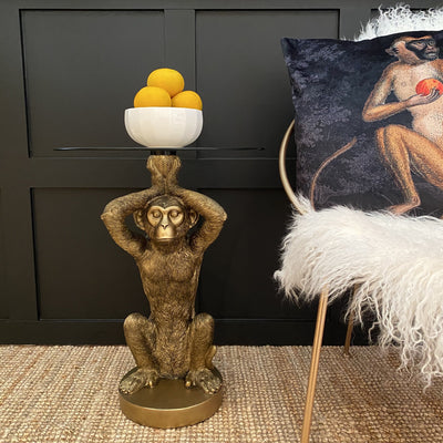 Gold monkey statue side table with a round glass top
