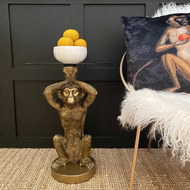 Gold monkey statue side table with a round glass top