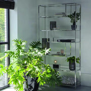 Freestanding nickel silver shelving unit with staggered geometric clear glass shelves