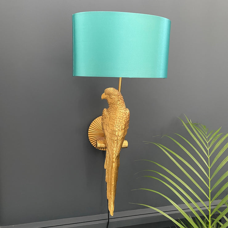 Gold parrot wall light with an aqua blue shade