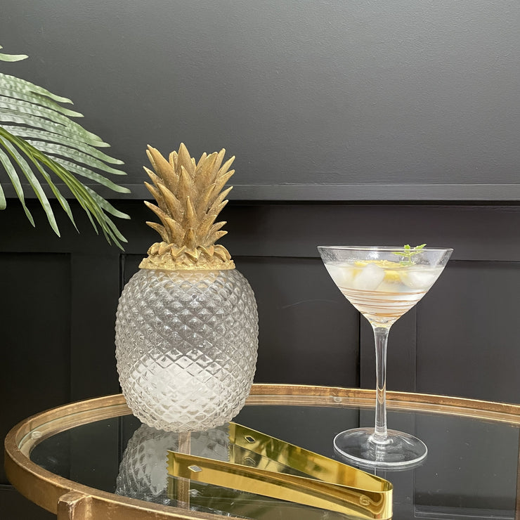 Clear glass pineapple jar with a gold lid