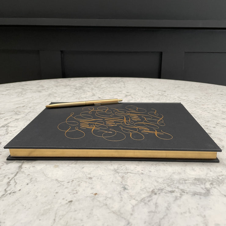 You got this shit gold calligraphy black notebook with gold edged paper